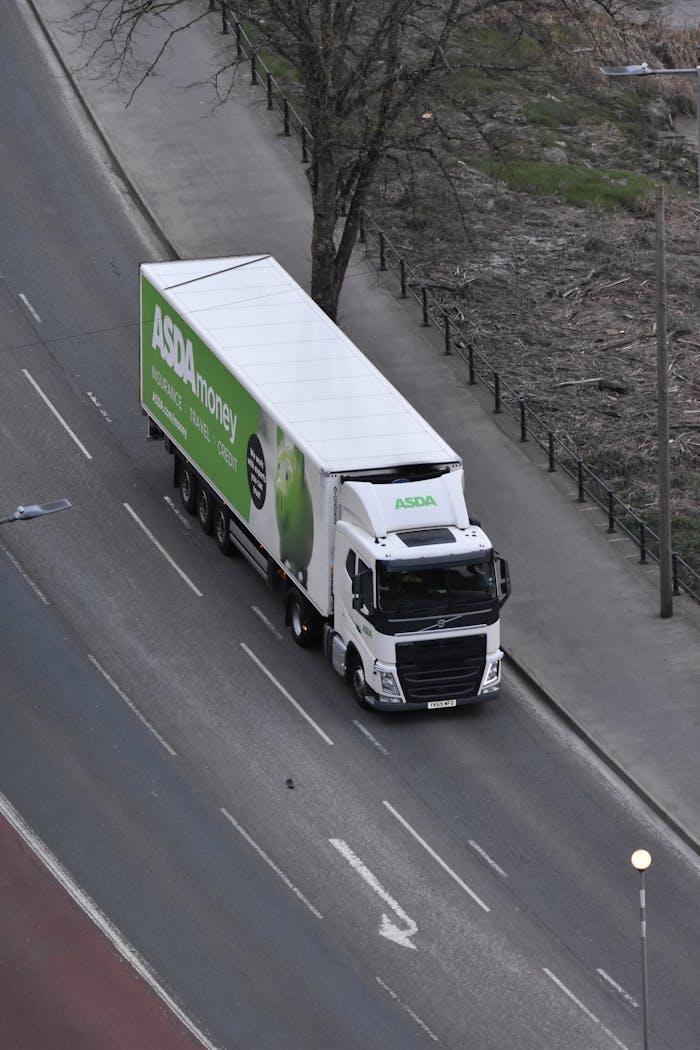 High angle view of an ASDA delivery truck driving on an urban street.